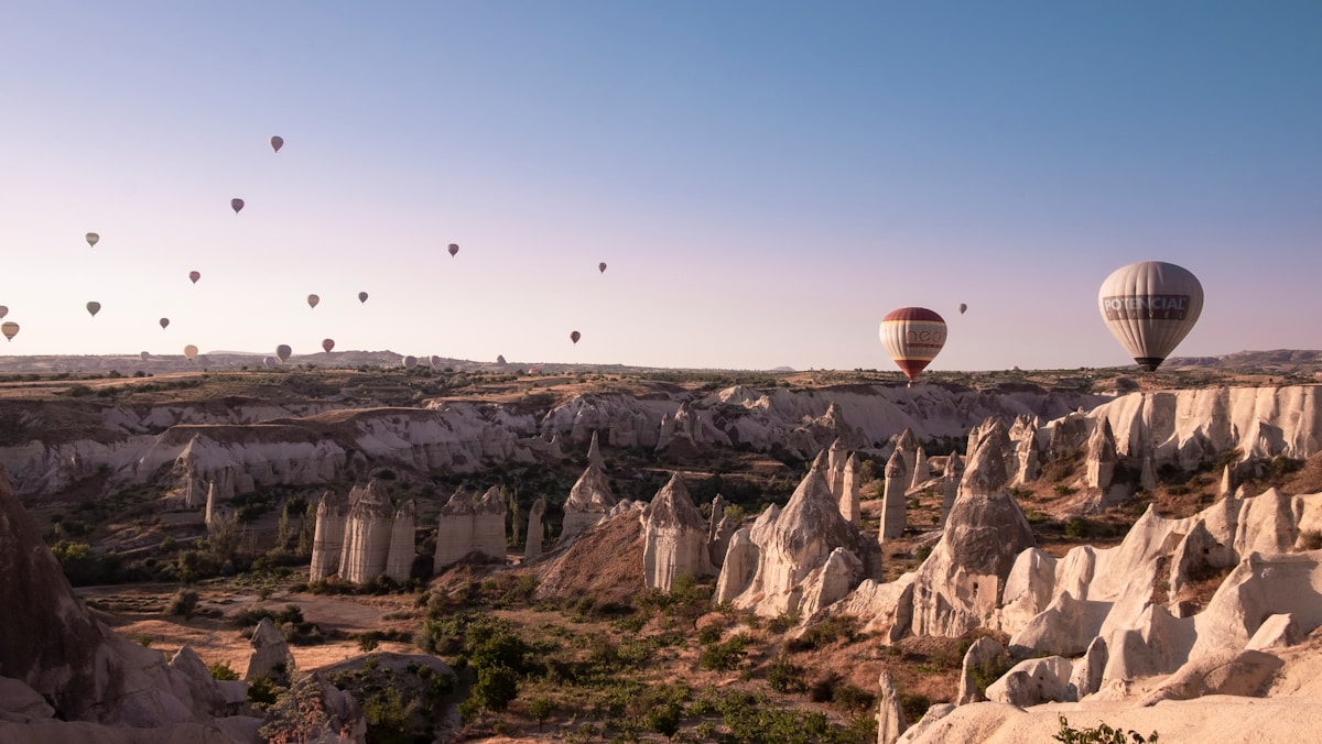 Hot air balloons floating over Cappadocia's fairy chimneys at sunrise